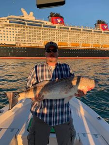 Fisherman holding a 33-inch fish at Cape Canaveral