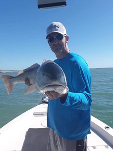 One fisherman at Cape Canaveral, Florida, holding a 17-inch fish.