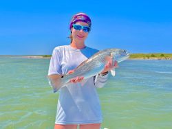 A lone angler reels in a 23-inch catch at the scenic Port Mansfield