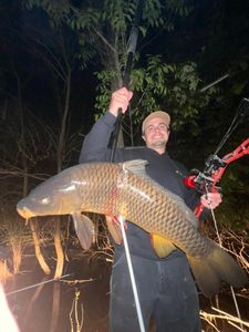 A person fishing for a common carp in Burlington