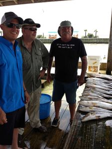 Three people fishing at Galveston