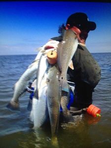 2 fishing rods with caught fish in Galveston