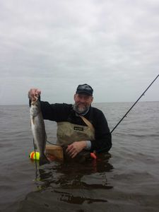 Angler holding a spotted weakfish catch in TX