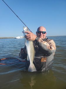 Angler holding a spotted weakfish, 22 inches long, in Galveston