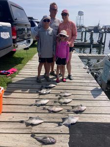 Two people fishing with rods in Wanchese