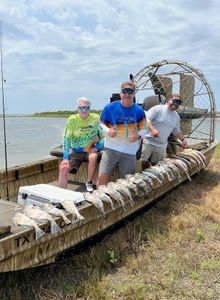 3 people fishing on the shore in TX