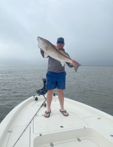Two people fishing in Hopedale with a 22-inch fish