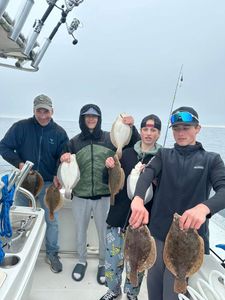Fishing trip with 4 people and 5 european flounder, summer flounder fish