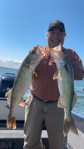 A person fishing in Beulah with two fish