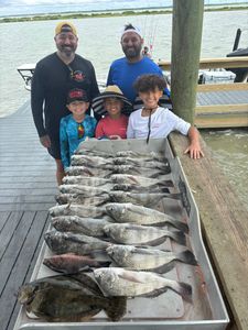 Successful fishing trip in Corpus Christi TX showing catch of Southern Flounder and Black Drum on dock