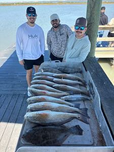 Fresh caught redfish displayed on dock after successful fishing trip in Corpus Christi TX