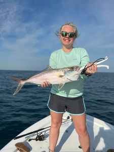 A fisherman holding a big greater amberjack fish in South Carolina