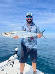 A fisherman holding a large king mackerel fish in Mount Pleasant