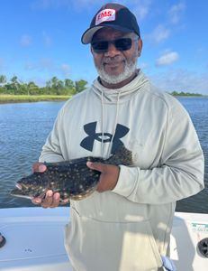 Angler holding a summer flounder catch in Mount Pleasant