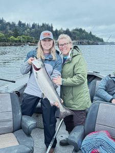 Two people enjoying a fishing trip in Reedsport
