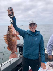 A person fishing in Oregon with a 22-inch fish