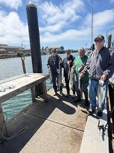 Fishing dock in Reedsport OR with wooden pier and marina in background