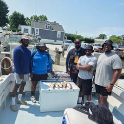 Successful fishing charter in Baltimore MD with fresh catch displayed in boat cooler
