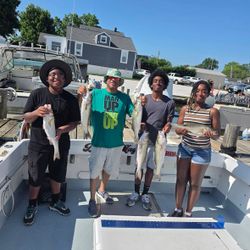 Successful fishing trip in Baltimore MD showing fresh caught fish on boat deck