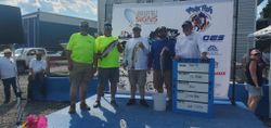 Striped bass fishing tournament weigh-in with fish displayed on stage in Baltimore MD