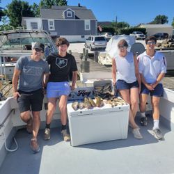 Four people enjoying a fishing cruise in MD