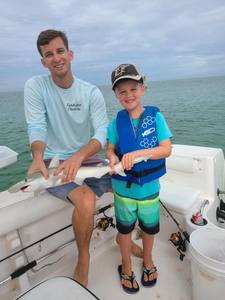 Anglers on the water in FL catching a 9-inch fish