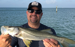 A snook, a large saltwater fish, caught on a fishing trip at Madeira Beach