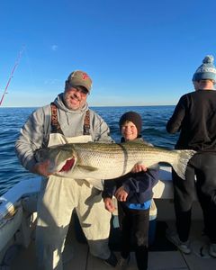 Anglers standing in shallow water near the NJ shore