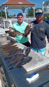 Two anglers fishing in New Jersey with 2 fish