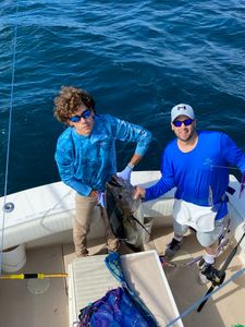 Two anglers enjoying a fishing trip in NJ