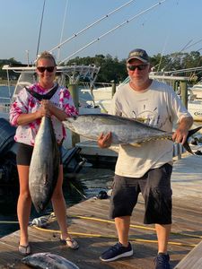 Two blackfin tuna, each around 27 inches, caught by two people in Neptune City
