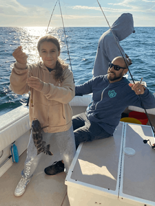 Two people enjoying a fishing trip in Neptune City