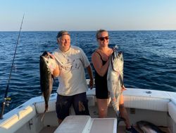 Two anglers fishing in New Jersey with two big fish