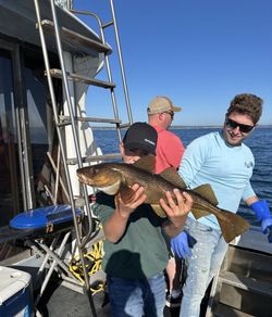 Three people enjoying fishing, tours, and water sports activities in NS