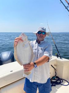Person fishing in Belmar with a single caught fish