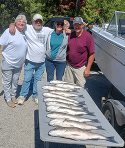 A group of 4 people fishing with 3 big fish in South Carolina