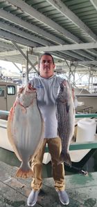 Two anglers fishing for striped bass in Richmond
