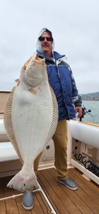 A person fishing in Richmond, California for a California Flounder.
