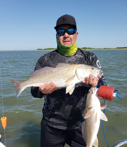 Two anglers with their catch of Atlantic Croaker fish in TX