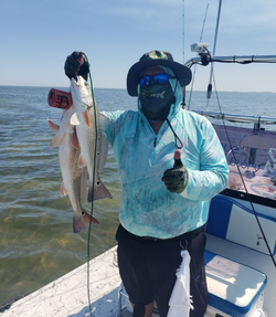 Angler with a 16-inch fish on the Rio Hondo