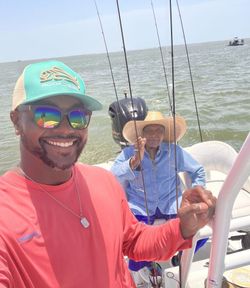 Fishing boat with multiple rods set up on water in Corpus Christi TX