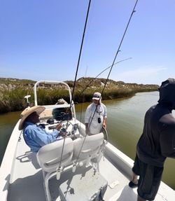 Fishing boat on calm waters near Corpus Christi TX with multiple fishing rods and anglers