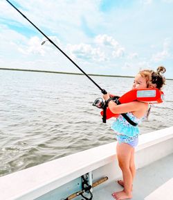 Young angler fishing from boat deck in Corpus Christi TX waters