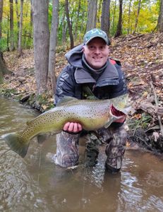 Angler holding a large rainbow trout in Connecticut