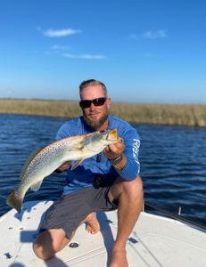 Angler poses with a spotted weakfish catch in Florida.