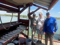 Three people fishing in TX
