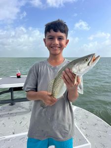 A fisherman holding a 11-inch fish in TX