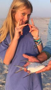 A fisherman catches a Great Pompano at Perdido Key