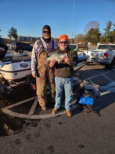 Two anglers displaying caught crappie at boat launch in Cumming GA