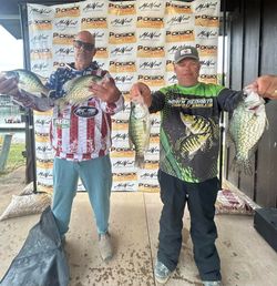 Two anglers displaying caught crappie at fishing tournament in Cumming GA